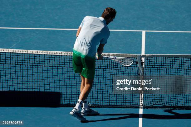 Daniil Medvedev smashes a tv net camera installed on the net with his racket as he has lost the third set against Kasidit Samrej of Thailand in the...