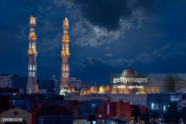 illuminated mosque at night with cloudy sky and full moon in hurghada - minaret stock pictures, royalty-free photos & images