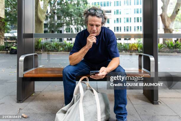 mature male commutes in the city - bus stop stock pictures, royalty-free photos & images