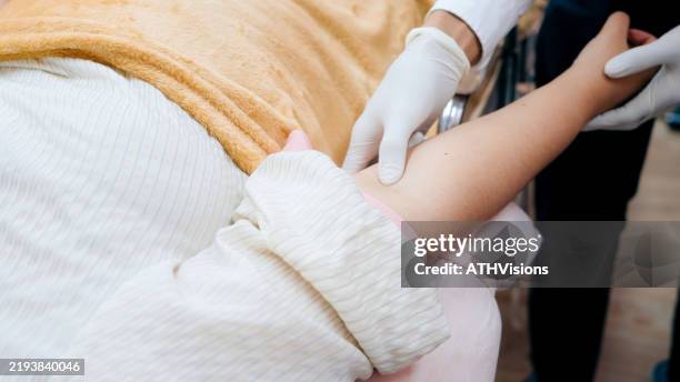 medical worker carefully performs an injection on a patient, emphasizing hygiene and professional healthcare standards. - vitamin iv stock pictures, royalty-free photos & images