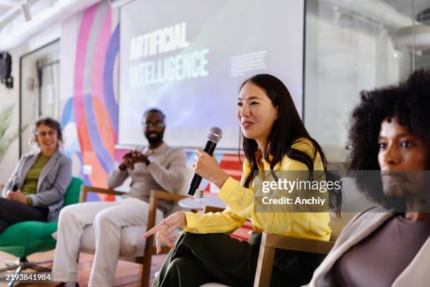 portrait of a japanese woman talking on an ai panel discussion - business conference stock pictures, royalty-free photos & images