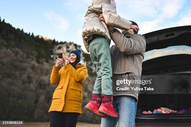 playful family field trip with car. - laarzen geel stockfoto's en -beelden
