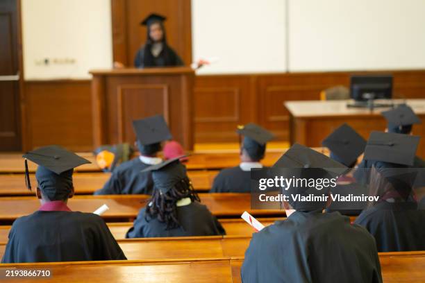 students listening to a farewell speech during a baccalaureate ceremony - graduation 2021 stock pictures, royalty-free photos & images