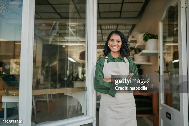 smiling small business owner of neighbourhood deli standing proudly in front of their shop - charming neighborhood stock pictures, royalty-free photos & images
