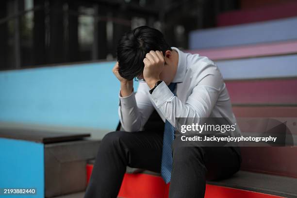 a businessman who was fired from his position is seen exiting the workplace. - hoffnungslosigkeit stock-fotos und bilder
