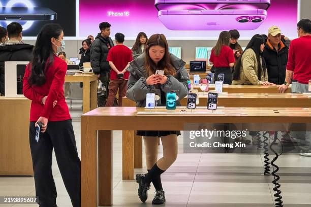 Customers explore the latest Apple products, including the iPhone 16, inside an Apple Store on January 14, 2025 in Chongqing, China. Chinas economy...