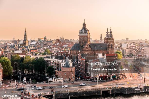amsterdam old town skyline with basilica of st. nicholas at sunset, aerial view, netherlands - basilica of st nicholas amsterdam stock pictures, royalty-free photos & images
