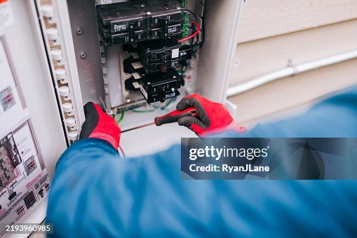 Electrician Working on Solar Panel Specific Electrical Panel Electrician Working on Solar Panel Specific Electrical Panel