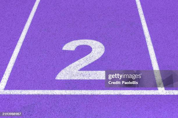 purple running track with numbered lanes - number 2 stock pictures, royalty-free photos & images