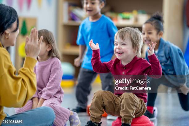 sing-along circle time! - down syndrome stock pictures, royalty-free photos & images
