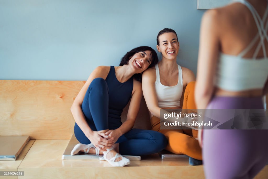Relaxed Friends in Activewear Sharing Time at a Yoga Studio
