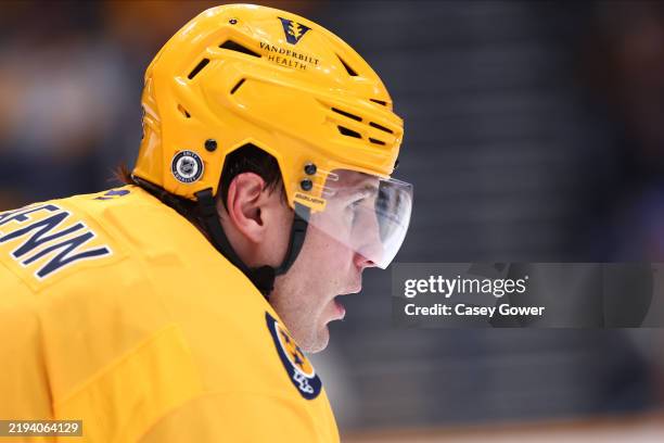 Luke Schenn of the Nashville Predators looks onto a face-off in the first period against the Minnesota Wild on January 18, 2025 at Bridgestone Arena...