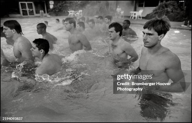 View of members of the University of California Berkeley's California Golden Bears football team in a campus swimming pool, Berkeley, California,...