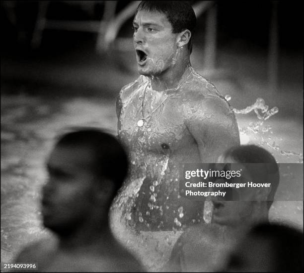 View of members of the University of California Berkeley's California Golden Bears football team in a campus swimming pool, Berkeley, California,...