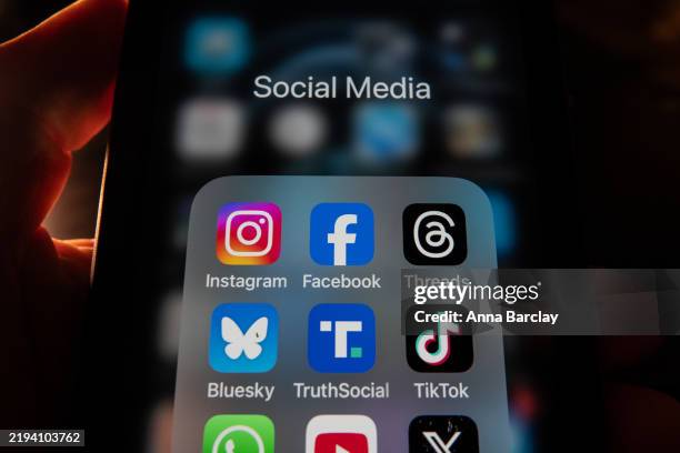 In this photo illustration a smartphone screen displays the logos of Meta's social media apps Instagram the logo of Facebook and Threads , on January...