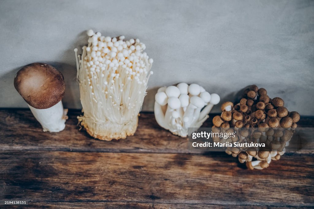 Hight angel view on edible Asian mushrooms on wooden tables.