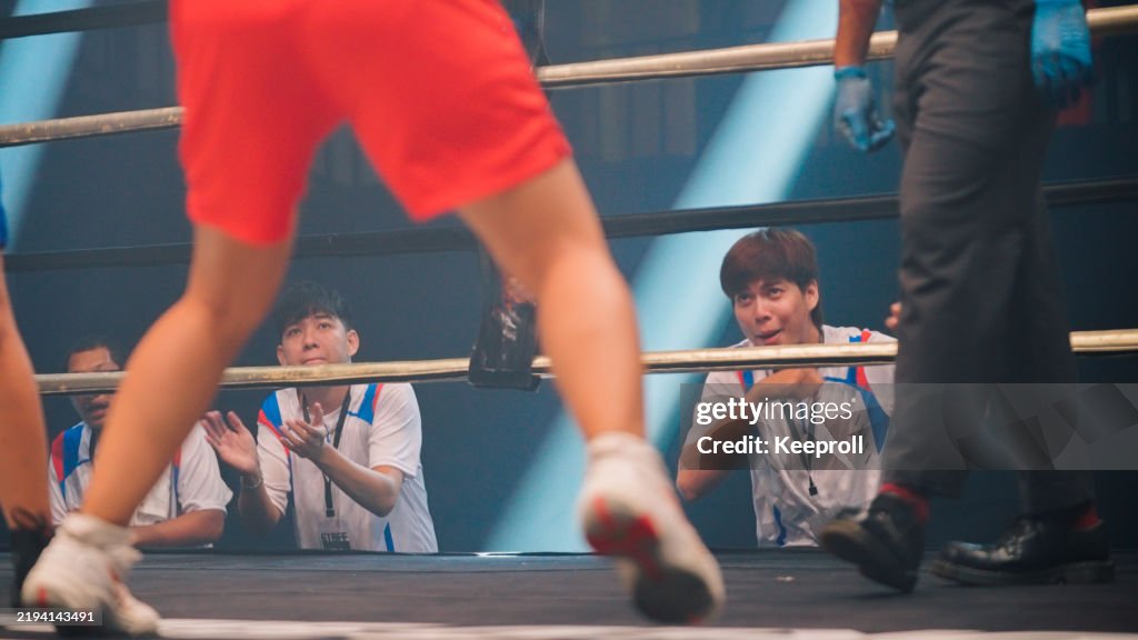 Coach are cheering women boxer in boxing match