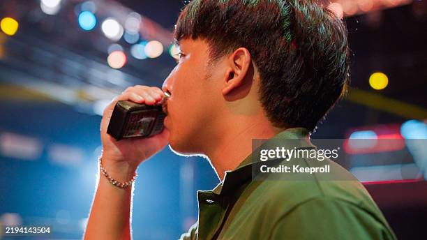 asian employee talking on walkie talkie with his teammate on boxing day - stadium queue stock pictures, royalty-free photos & images