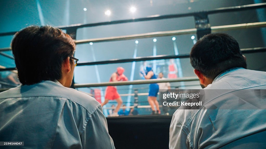Referee are checking game point during boxing match