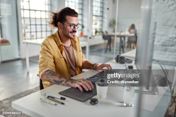 happy programmer working on desktop pc in the office. - software programmer stock pictures, royalty-free photos & images
