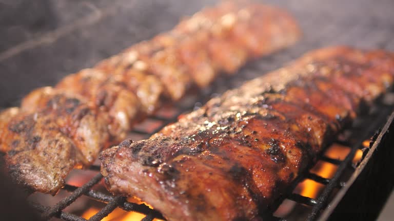 https://media.gettyimages.com/id/2194155649/video/barbecue-grill-juicy-barbecue-ribs-cooked-on-smoky-grill.jpg?b=1&s=640x640&k=20&c=rMcwT8-SC3NYXNeE3BNrZLoSZA7u3v5-qvIQ4XnL_u0=