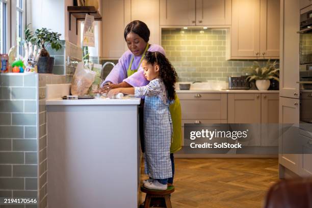 mother and daughter's easter baking moment - religious celebration stock pictures, royalty-free photos & images
