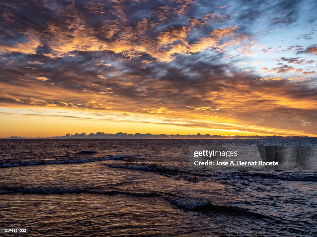 Coastal landscape at dawn minutes before the sun rises on the horizon.