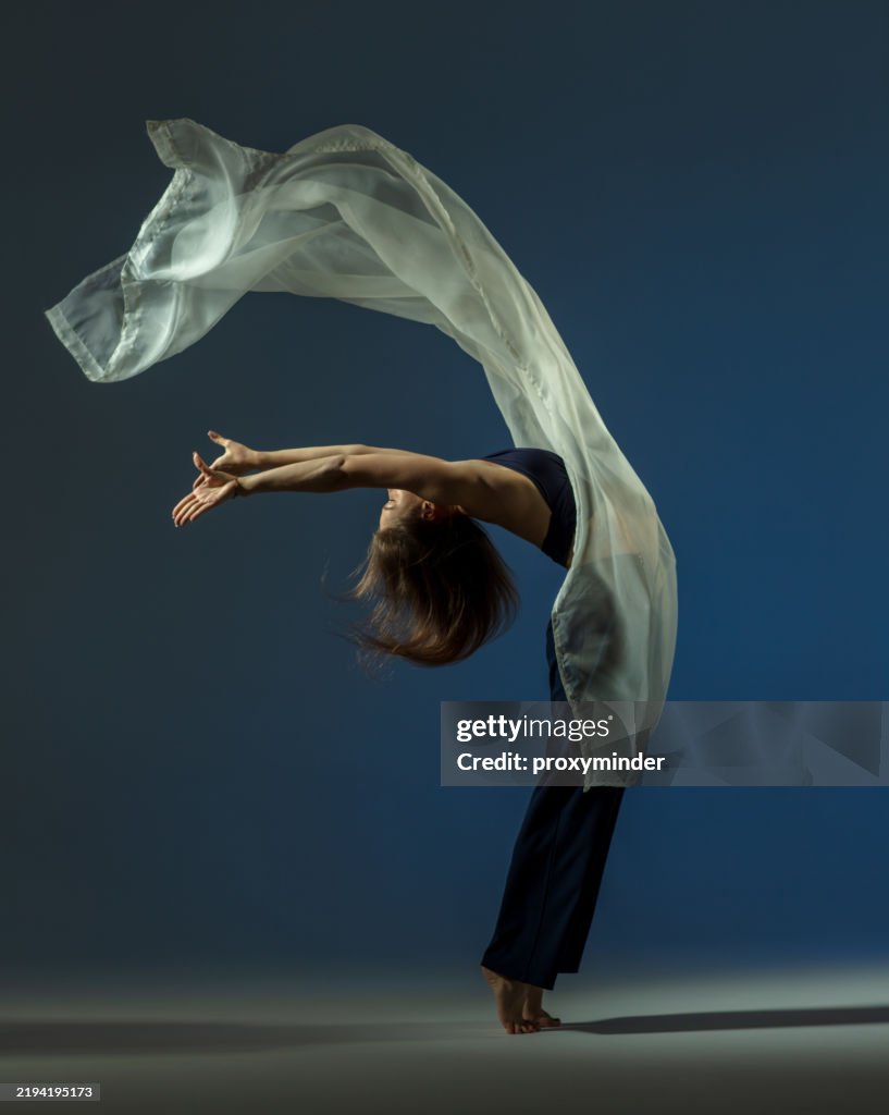 Dancer on blue background with white fabric