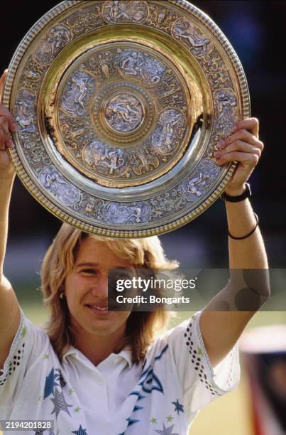 German tennis player Steffi Graf with the Venus Rosewater Dish after the Women's Singles final of the Wimbledon Championships tennis tournament, at...