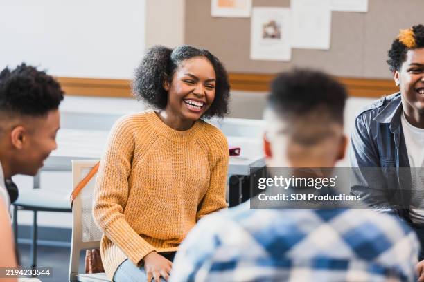 diverse group of high school students engaged in a lively discussion - female high school student stock pictures, royalty-free photos & images
