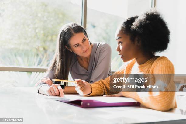 tutoring session: teacher and student working together - student support stock pictures, royalty-free photos & images