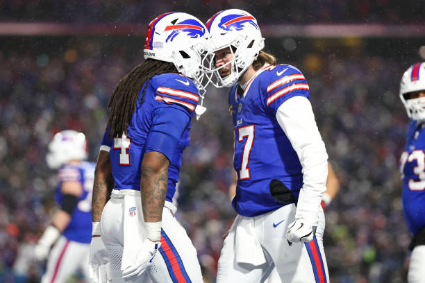 Josh Allen of the Buffalo Bills celebrates with James Cook of the Buffalo Bills after scoring a touchdown during the second quarter in the AFC...