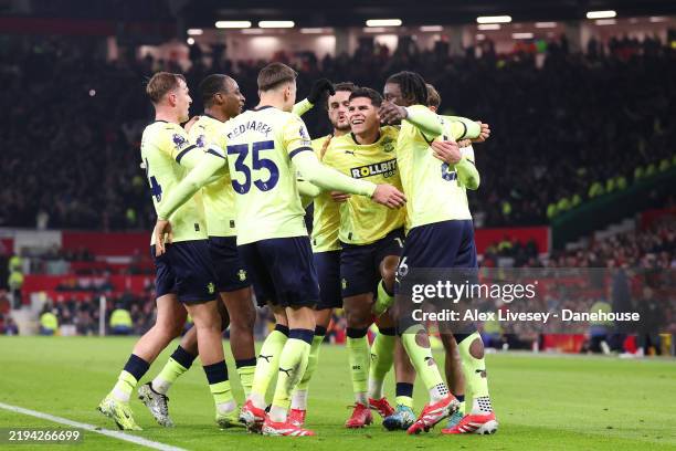 Mateus Fernandes of Southampton celebrates with teammates after Manuel Ugarte of Manchester United scores an own goal to score the visitor's first...