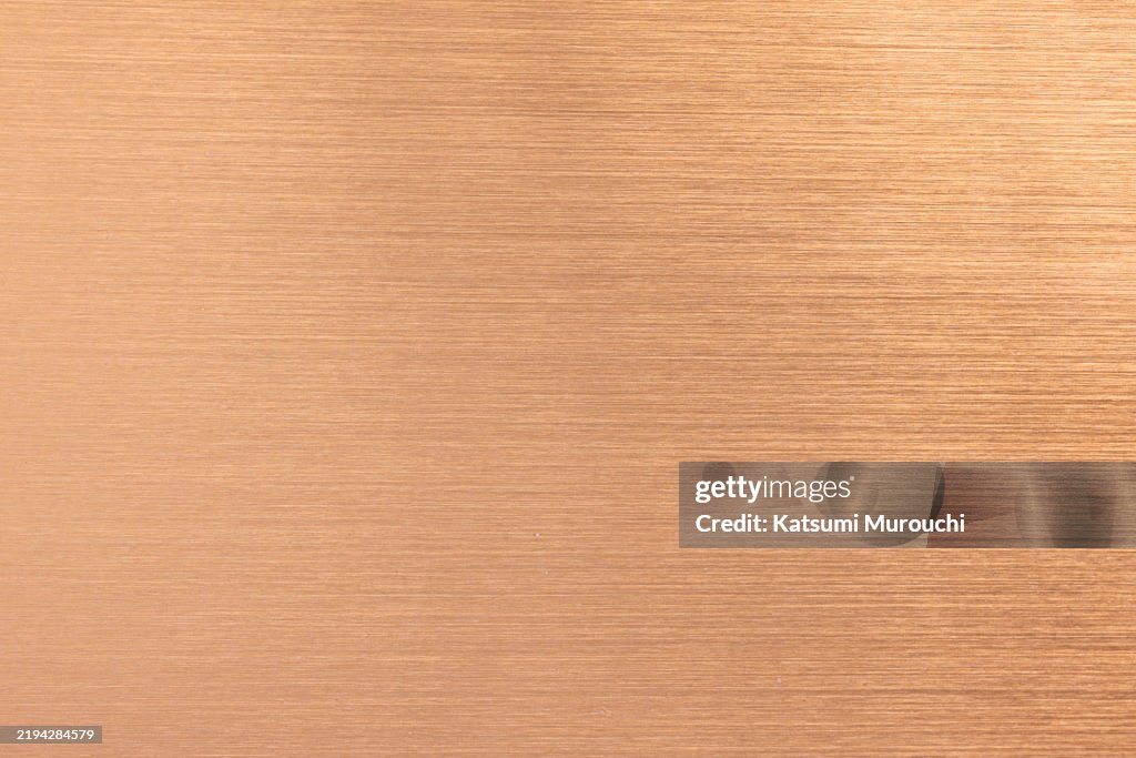 Bronze metallic hairline textured background