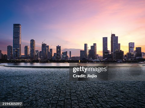 Empty town square against urban skyline at sunset Empty town square against urban skyline at sunset
