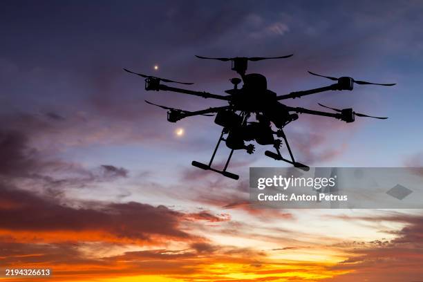 military drone with a bombs at sunset. combat drone in military conflicts - drone stock pictures, royalty-free photos & images