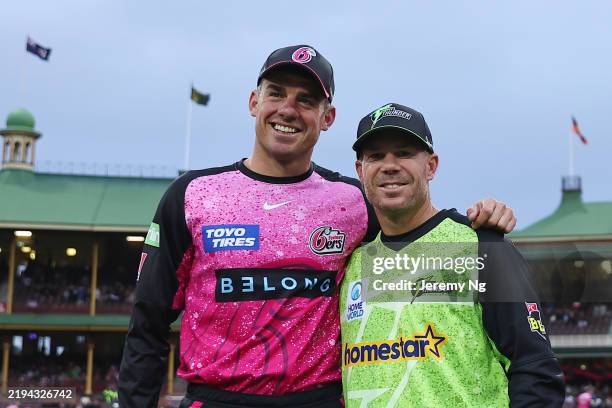 David Warner of the Thunder and Moises Henriques of the Sixers pose for a photo during the BBL match between Sydney Sixers and Sydney Thunder at...