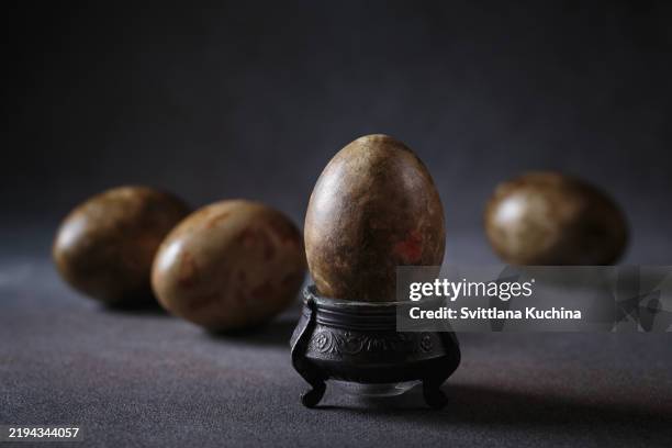 decorative egg and stand with moody shadows and soft focus - atmospheric mood stock pictures, royalty-free photos & images