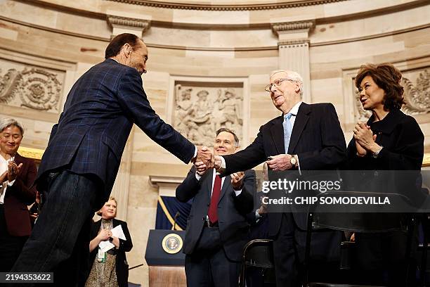Singer-songwriter Lee Greenwood greets U.S. Sen. Mitch McConnell after performing during the inauguration of U.S. President-elect Donald Trump in the...