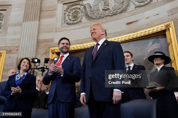 Vice President-elect J.D. Vance and U.S. President-elect Donald Trump onstage before taking their oaths of office during the Inauguration of Donald...