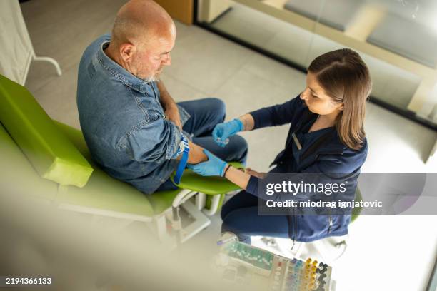 nurse taking blood from elderly patient - blood donation stock pictures, royalty-free photos & images