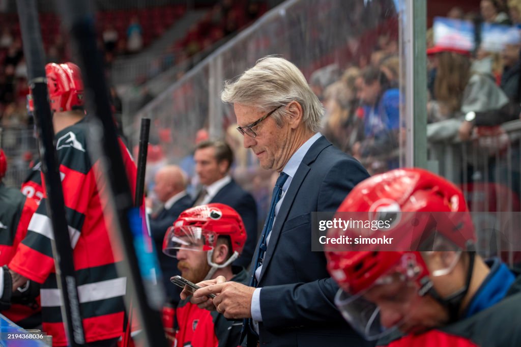 Professional Ice Hockey Match: Coach Using Smartphone