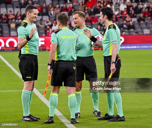 Match referees shake hands prior to the round 15 A-League Men match between Western Sydney Wanderers and Central Coast Mariners at CommBank Stadium,...
