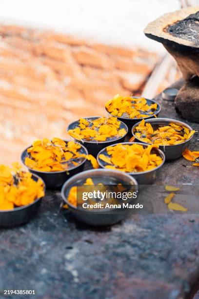 orange flowers as religious offerings at buddha stupa in kathmandu - kathmandu nepal stock pictures, royalty-free photos & images