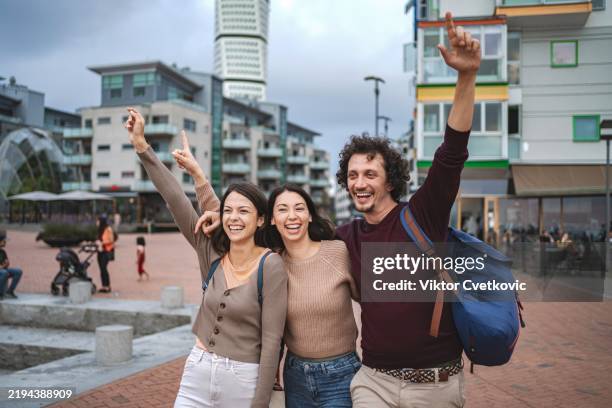 tourists pointing at turning torso in malmo, sweden - malmö bildbanksfoton och bilder