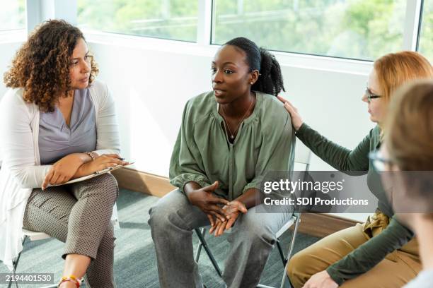 group therapy session: women sharing experiences and support - empathy stock pictures, royalty-free photos & images