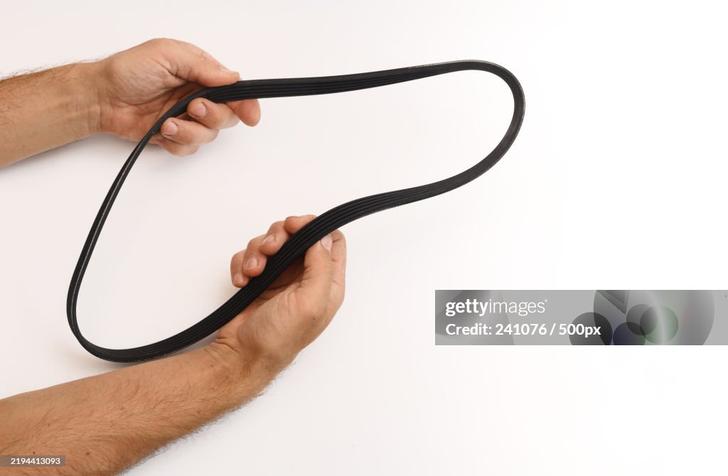 The belt of the car generator spare parts on a white background in