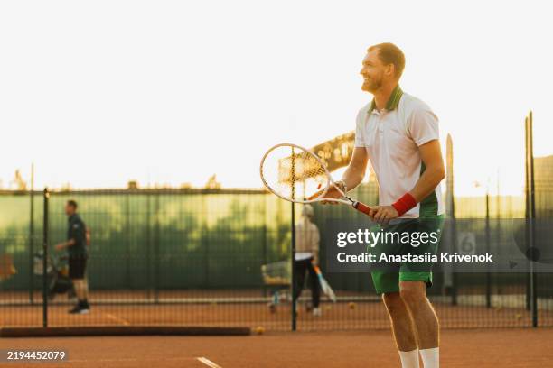 professional tennis player about to hit the ball for the serve. - atuendo de tenis fotografías e imágenes de stock
