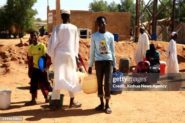 Sudanese resident carries plastic water containers in Omdurman city, north of the Sudanese capital Khartoum, Jan. 18, 2025. For over a week, the...