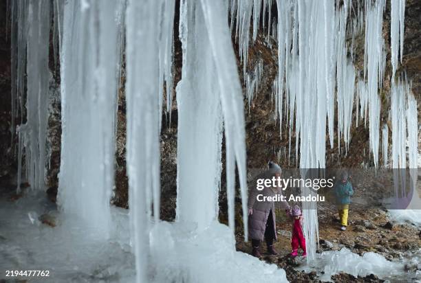 People pose for a photo while exploring the spectacular icefall Siklava Skala in Spisska Nova Ves district, Slovakia on January 20, 2025. The icefall...